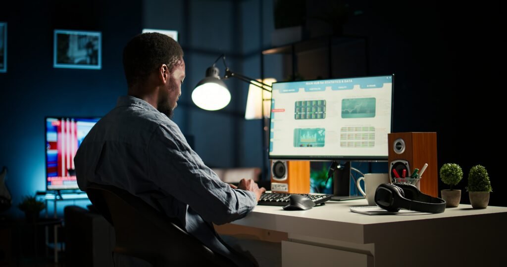 african american investment expert works home analyzing financial statistics